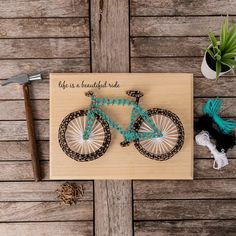 a wooden sign that says life is a beautiful ride with a bicycle on the front