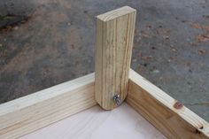 a close up of a wooden frame with screws