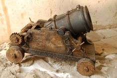 an old wooden toy car with gears attached to it's front wheel and wheels