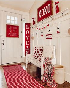 a red and white valentine's day entryway with love signs on the wall