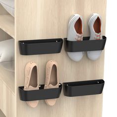 three pairs of shoes are hanging on the wall next to two bins with shoe holders