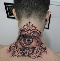 the back of a man's neck with an eye tattoo on it