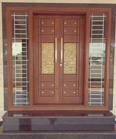 a large wooden door with glass panels on it