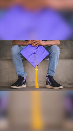 a person sitting on a bench with a purple graduation cap and tasseled book