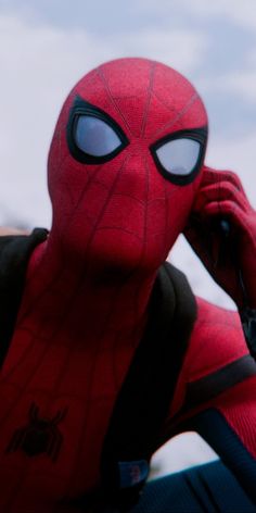 the spider man is talking on his cell phone