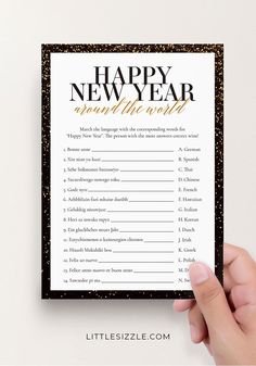 a hand holding up a new year's resolution card with the words happy new year around the world