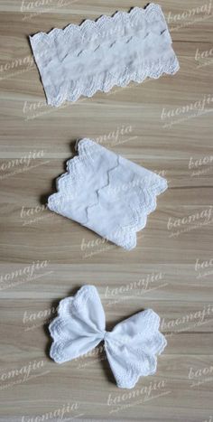 two pieces of white lace sitting on top of a wooden table