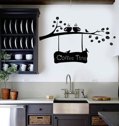 a wall decal that says coffee time hanging from a tree branch