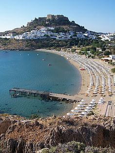 an aerial view of a beach with many umbrellas