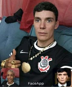 a man in a black shirt is holding two gold rings and looking at the camera