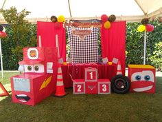 an outdoor birthday party with cars and decorations