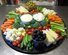 a platter filled with vegetables and dip