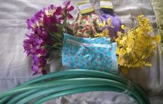 flowers and garden hoses laid out on a bed