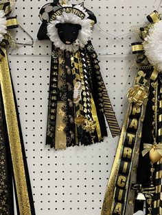 two black and gold ribbons hanging on a wall next to each other in a store