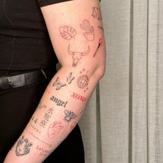 a woman's arm with tattoos on it