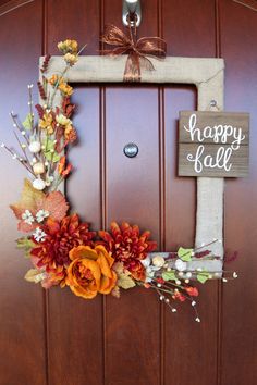 a wooden door with a happy fall sign hanging on it's side next to a wreath