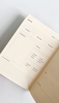 an open planner book sitting on top of a table