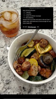 a bowl filled with meat and vegetables next to a drink