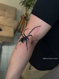 a person with a spider tattoo on their arm