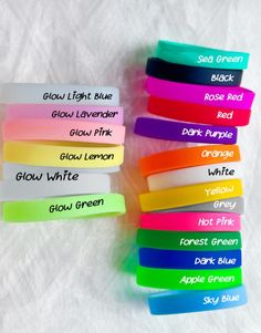 several different colored wristbands with names on them