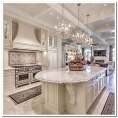 a large kitchen with an island and chandelier