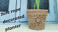 a crocheted planter sitting next to a door with the words jute rope decorated on it