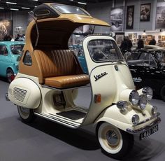 an old car is parked in a showroom