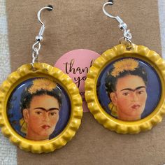 Handmade Artisan Bottle Cap Earrings. Sterling Silver Hook. Image: Portrait Of Painter Frida Kahlo. The Item You Will Receive Is A Work Of Art. It Is A One Of A Kind. No Two Earring Sets Are Identical. The Size: The Image Is The Size Of A Quarter. Warning: Not Suitable For Children. Contains Small Parts That Could Be A Chocking Hazard. Artistic Adjustable Yellow Earrings, Adjustable Artistic Yellow Earrings, Quirky Blue Jewelry For Gifts, Quirky Blue Jewelry For Gift, Bottle Cap Earrings, Nickel And Suede, Vintage Clip Earrings, Kendra Scott Earrings, Earring Sets