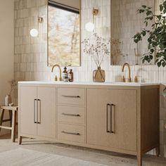 a bathroom with two sinks and mirrors on the wall