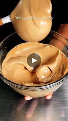 a person pouring peanut butter into a bowl