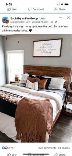 the bed is made up with brown and white blankets on it, along with pillows