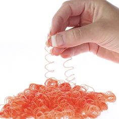 Orange Ringlet Doll Hair - True Vintage. Orange Ringlet Doll Hair. Covers an area approximately of one square foot in size. Made of polypropylene filament.    This can be attached to all different kinds of fabric-made dolls, such as muslin, cotton, and even wood or raffia. Make a majestic mermaid with long, flowing hair! A happy, freckled country girl to accent your rocking chair and bed's accent pillows! A graceful ballerina with wispy bangs that spring up and down as she twirls! A smiling, sparkling angel that will fit perfectly on your tree! Add bows and ribbons to complete your doll's look!    Grab several strands of ringlets and cut to twice the desired length. Hold strands in the middle, and attach them to your desired surface with a dab of hot glue, white glue, or stitch. Start at t Bed Accent Pillows, Hair Covers, Flowing Hair, Wispy Bangs, Kinds Of Fabric, White Glue, Vintage Orange, Doll Hair, Vintage Doll