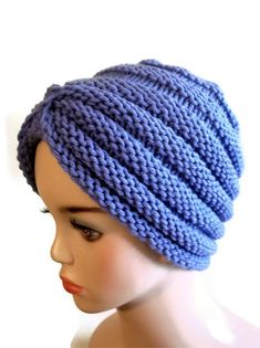 a mannequin head wearing a blue knitted hat