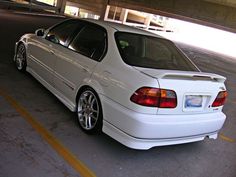 a white car parked in a parking garage