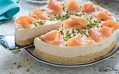 a cheesecake topped with salmon and pistachio