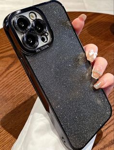 a woman's hand holding an iphone case that has glitter on it and is next to a starbucks cup