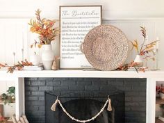 a black fireplace with a white mantle and some decorations on top