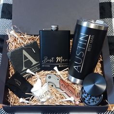 a gift box containing two personal flasks, an aluminum cup and a lighter