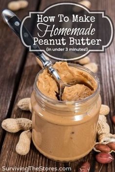 peanut butter in a jar with peanuts around it and a spoon sticking out of the jar