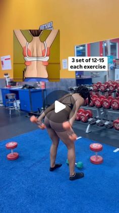 the woman is practicing her moves on the blue carpet in front of rows of red dumbbells