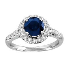 a blue sapphire and diamond ring on a white background