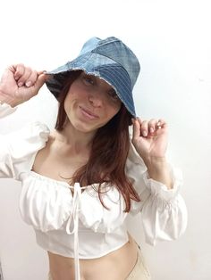 a woman wearing a white top and blue hat