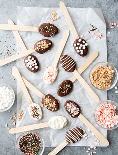 chocolate covered marshmallows and pretzels are arranged on top of paper