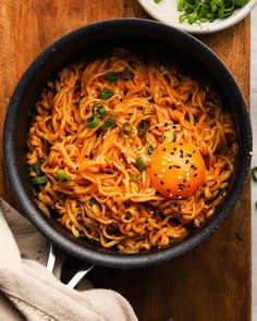 a bowl of noodles with an egg on top