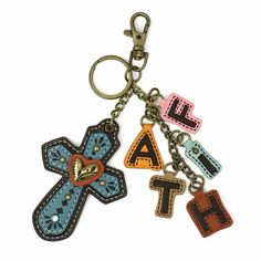 two key chains with letters and a cross