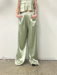 The Paris Pant is a high-waisted, wide-leg pant. Classic & elegant these beautiful pants have a lovely drape with soft front pleats. Love. 100% Triacetate Model is 5'9 and wears a size small Chic Satin Wide Leg Pants In Solid Color, Wide-leg Culottes For Spring Evening, Spring Wide-leg Culottes For Evening, Spring Evening Wide-leg Culottes, Chic Satin Wide Leg Full Length Pants, Elegant Green Wide Leg Pants, High Waist Green Bottoms For Evening, Green Wide Leg Pants For Summer Formal, Green Wide Leg Pants For Formal Summer Events