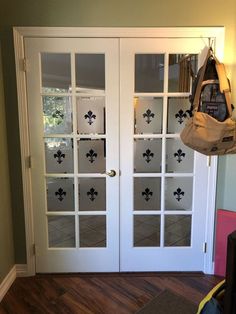 a white door with glass panels and a bag hanging on it