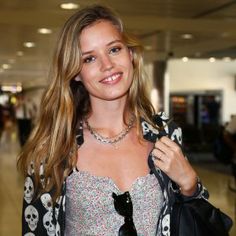 a beautiful young woman standing in an airport