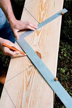 a person cutting wood with a pair of scissors