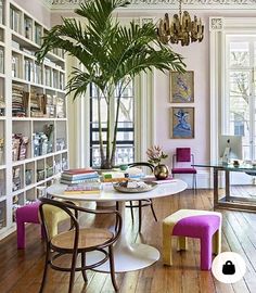 a living room filled with lots of furniture and a tree in the middle of it